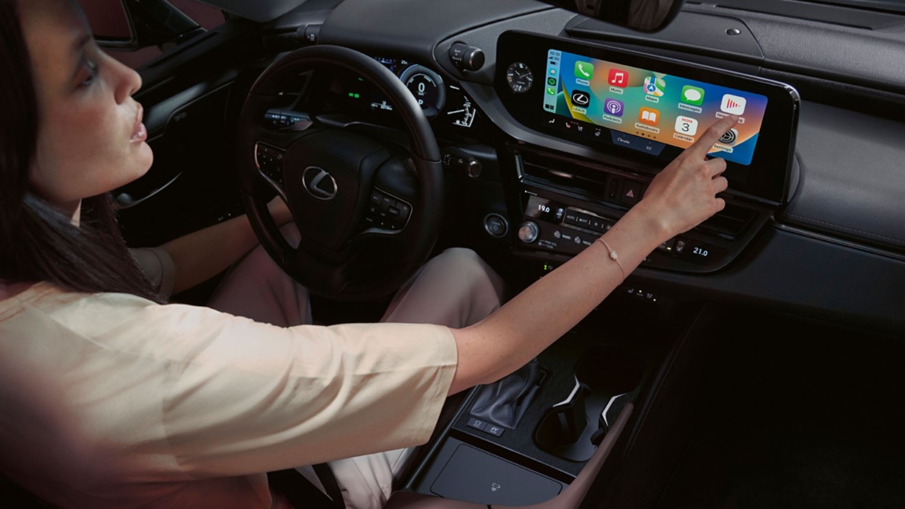 A person interacting with a Lexus touchscreen display