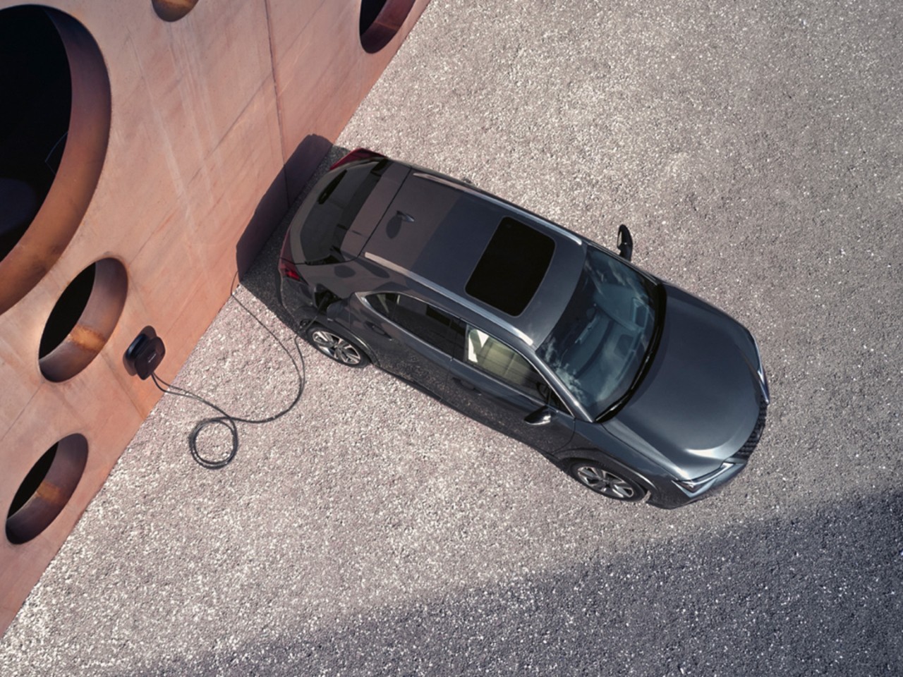 Lexus UX 300e plugged into a charging wallbox